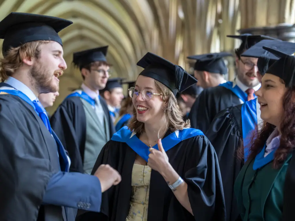 Graduands chatting as they wait in the cathedral grounds. 