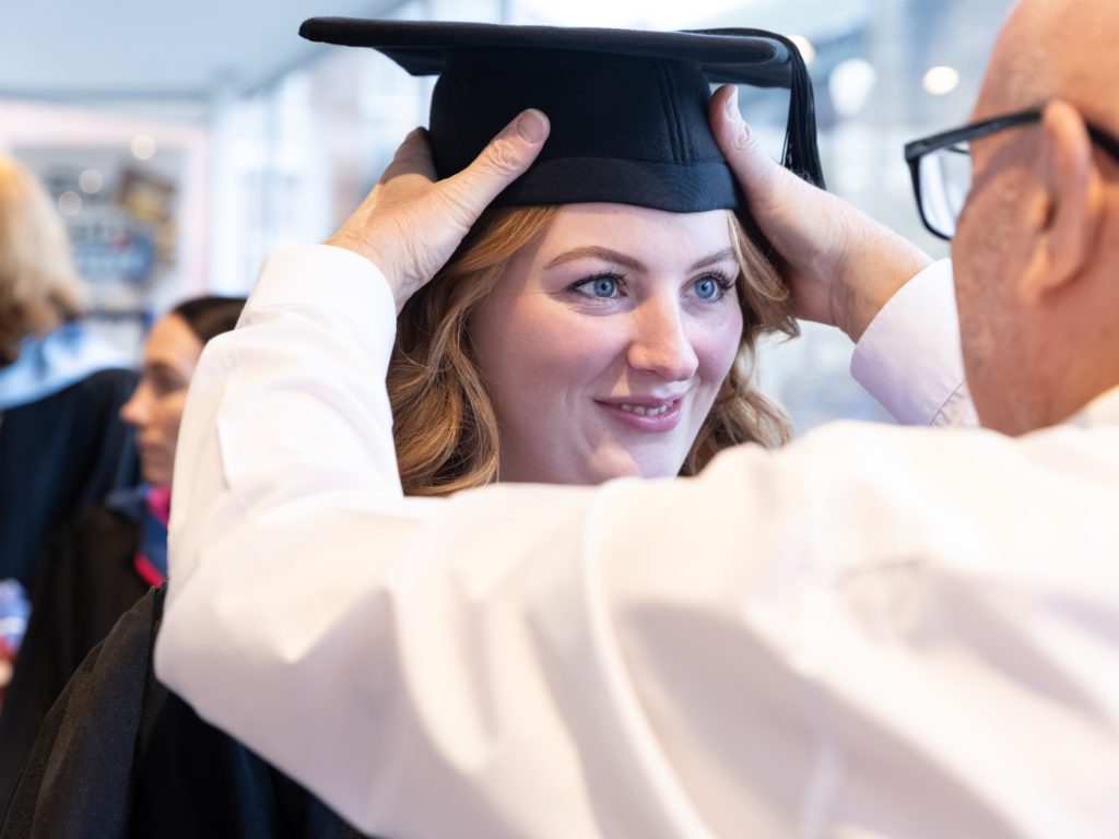 Graduand getting fitted for her cap